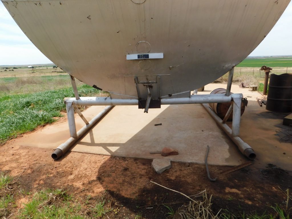 Grain Bin: 210- barrel slant bin made on skid being sold separately from the surface. 10’ wide x 16’ long x 20’ tall