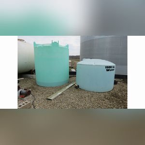 Several flat-bottom poly tanks, 1,550, 2,500 & 6,000 gal.