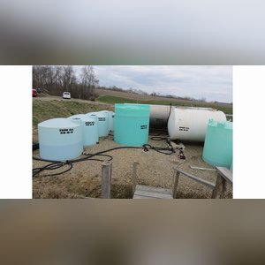 Several flat-bottom poly tanks, 1,550, 2,500 & 6,000 gal.