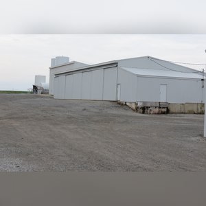 This 42â??x58â?? building is attached to the west end of Building B. It includes a small office area, concrete floor, (2) 15â??x17â?? sliders, walk-in door, and 220 amp single-phase & 3-phase electric.