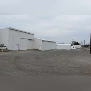 This 42â??x58â?? building is attached to the west end of Building B. It includes a small office area, concrete floor, (2) 15â??x17â?? sliders, walk-in door, and 220 amp single-phase & 3-phase electric.