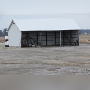 This building is a 26â??x50â??, 3-sided pole shed with 11.5â?? eves and gravel floor.