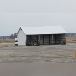 This building is a 26â??x50â??, 3-sided pole shed with 11.5â?? eves and gravel floor.