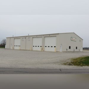 This steel-framed, completely insulated building boasts many custom features making it ideal for multiple purposes. It includes (3) office areas with built-in work surfaces, air conditioning, and LP gas forced-air heat. (2 offices are 12â??x11â?? & the other is 19â??x11â??.) The garage/shop area is 75â??x100â?? with concrete floors & approaches, (6) 16â??x16â?? overhead doors with openers, (4) walk-in doors, and loft storage area above offices. Additional amenities include (2) Reznor LP heaters, Energylogic waste oil furnace, ventilation system with louvered panels, ceiling fans, multiple electrical panels with 220 amp service, several outdoor electrical outlets with pigtail cords to plug in tractors, semis, etc., and a 10 HP 2-stage NAPA air compressor.