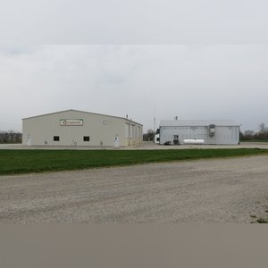 This steel-framed, completely insulated building boasts many custom features making it ideal for multiple purposes. It includes (3) office areas with built-in work surfaces, air conditioning, and LP gas forced-air heat. (2 offices are 12â??x11â?? & the other is 19â??x11â??.) The garage/shop area is 75â??x100â?? with concrete floors & approaches, (6) 16â??x16â?? overhead doors with openers, (4) walk-in doors, and loft storage area above offices. Additional amenities include (2) Reznor LP heaters, Energylogic waste oil furnace, ventilation system with louvered panels, ceiling fans, multiple electrical panels with 220 amp service, several outdoor electrical outlets with pigtail cords to plug in tractors, semis, etc., and a 10 HP 2-stage NAPA air compressor.