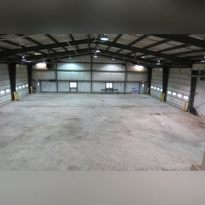 This steel-framed, completely insulated building boasts many custom features making it ideal for multiple purposes. It includes (3) office areas with built-in work surfaces, air conditioning, and LP gas forced-air heat. (2 offices are 12â??x11â?? & the other is 19â??x11â??.) The garage/shop area is 75â??x100â?? with concrete floors & approaches, (6) 16â??x16â?? overhead doors with openers, (4) walk-in doors, and loft storage area above offices. Additional amenities include (2) Reznor LP heaters, Energylogic waste oil furnace, ventilation system with louvered panels, ceiling fans, multiple electrical panels with 220 amp service, several outdoor electrical outlets with pigtail cords to plug in tractors, semis, etc., and a 10 HP 2-stage NAPA air compressor.