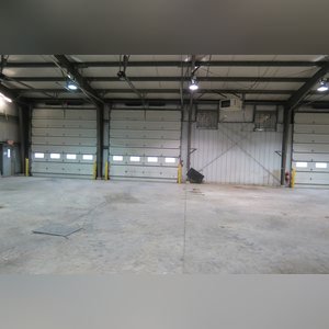This steel-framed, completely insulated building boasts many custom features making it ideal for multiple purposes. It includes (3) office areas with built-in work surfaces, air conditioning, and LP gas forced-air heat. (2 offices are 12â??x11â?? & the other is 19â??x11â??.) The garage/shop area is 75â??x100â?? with concrete floors & approaches, (6) 16â??x16â?? overhead doors with openers, (4) walk-in doors, and loft storage area above offices. Additional amenities include (2) Reznor LP heaters, Energylogic waste oil furnace, ventilation system with louvered panels, ceiling fans, multiple electrical panels with 220 amp service, several outdoor electrical outlets with pigtail cords to plug in tractors, semis, etc., and a 10 HP 2-stage NAPA air compressor.