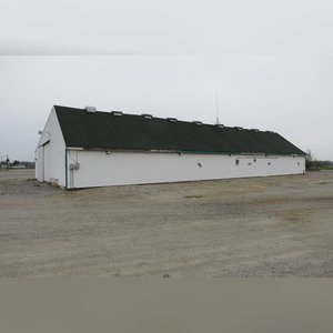 This drive-thru storage building is 60â??x105â?? with concrete floors, a front office area, a newer shingled roof, and 480 amp service. There are (8) 11â??x32â?? individual storage bays, (2) end-sliders, and (2) walk-in doors.