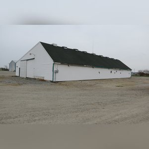 This drive-thru storage building is 60â??x105â?? with concrete floors, a front office area, a newer shingled roof, and 480 amp service. There are (8) 11â??x32â?? individual storage bays, (2) end-sliders, and (2) walk-in doors.