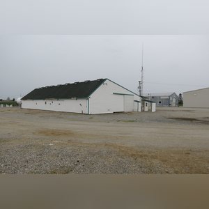 This drive-thru storage building is 60â??x105â?? with concrete floors, a front office area, a newer shingled roof, and 480 amp service. There are (8) 11â??x32â?? individual storage bays, (2) end-sliders, and (2) walk-in doors.